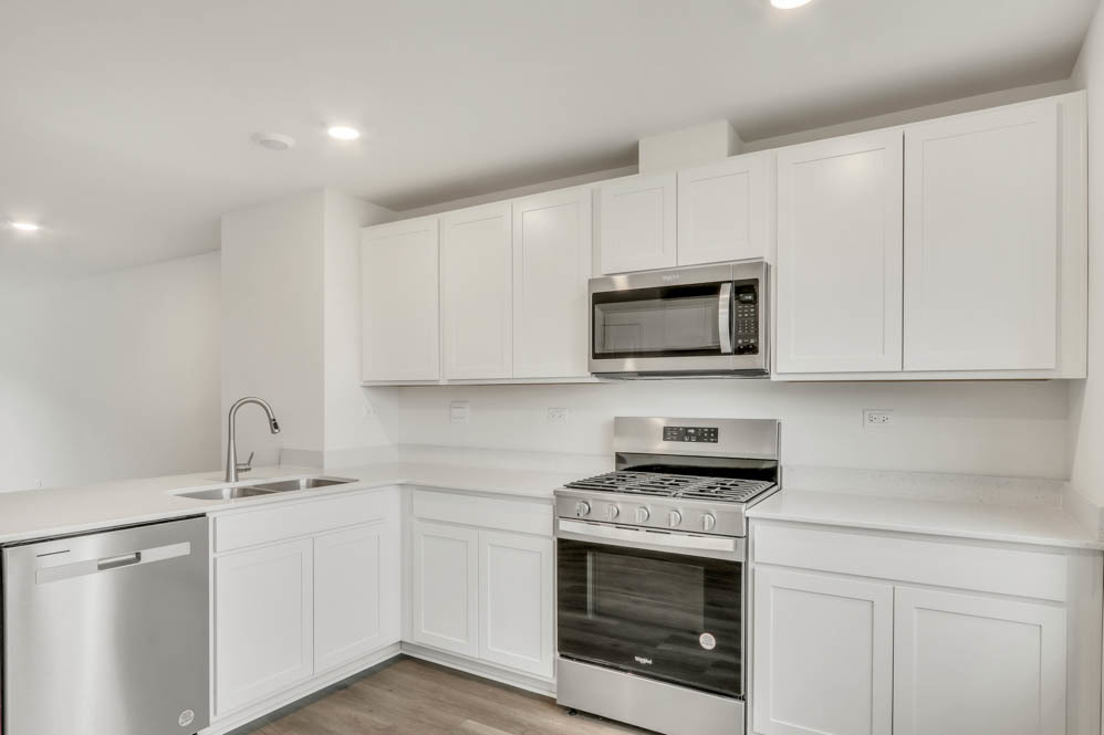 340 Basin Ct Street St. Charles, IL 60174 - Photo 14 of 29 a kitchen with white cabinets stainless steel appliances and sink
