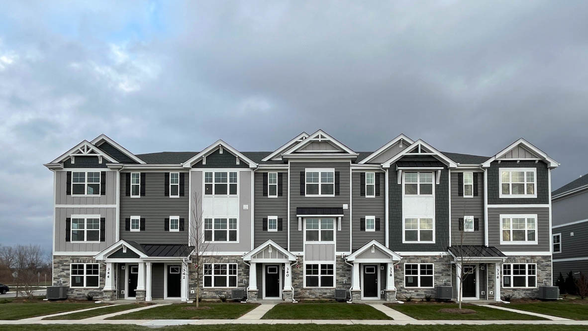 340 Basin Ct Street St. Charles, IL 60174 - Photo 2 of 29 a front view of a residential apartment building with yard and parking space