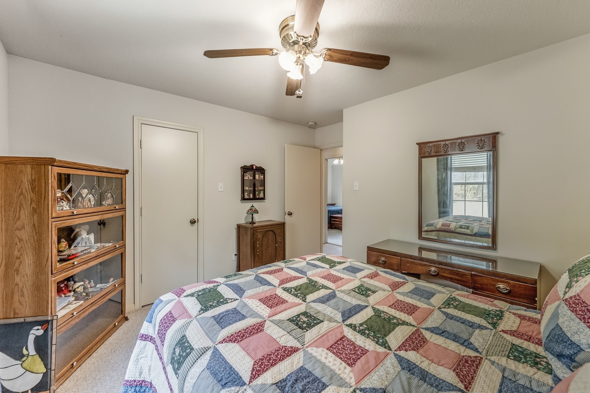691 Bishop Road Huntsville, TX 77320 - Photo 20 of 32 a bedroom with a bed and a chandelier