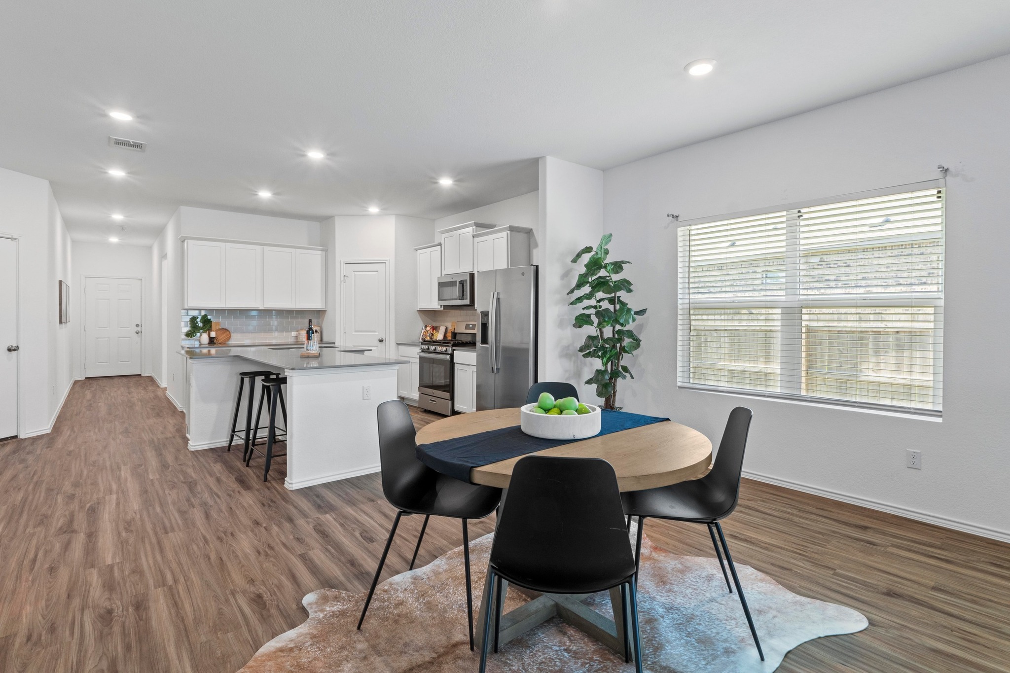 1705 Woolsey Way Leander, TX 78641 - Photo 11 of 35 a view of a dining room with furniture and wooden floor