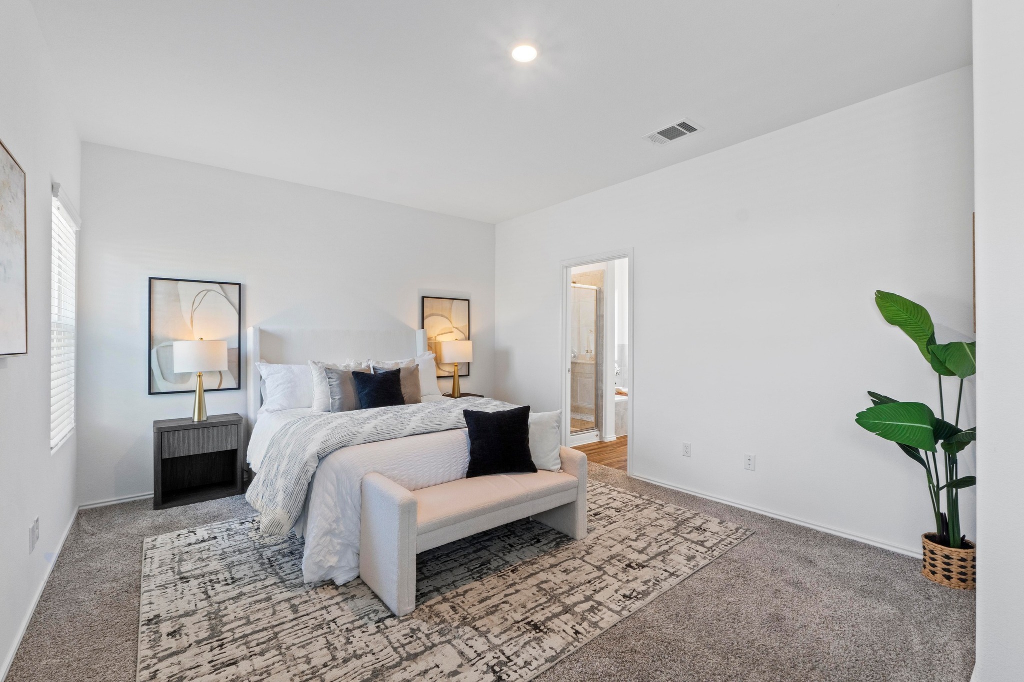 1705 Woolsey Way Leander, TX 78641 - Photo 19 of 35 a bedroom with a bed a couch and potted plant