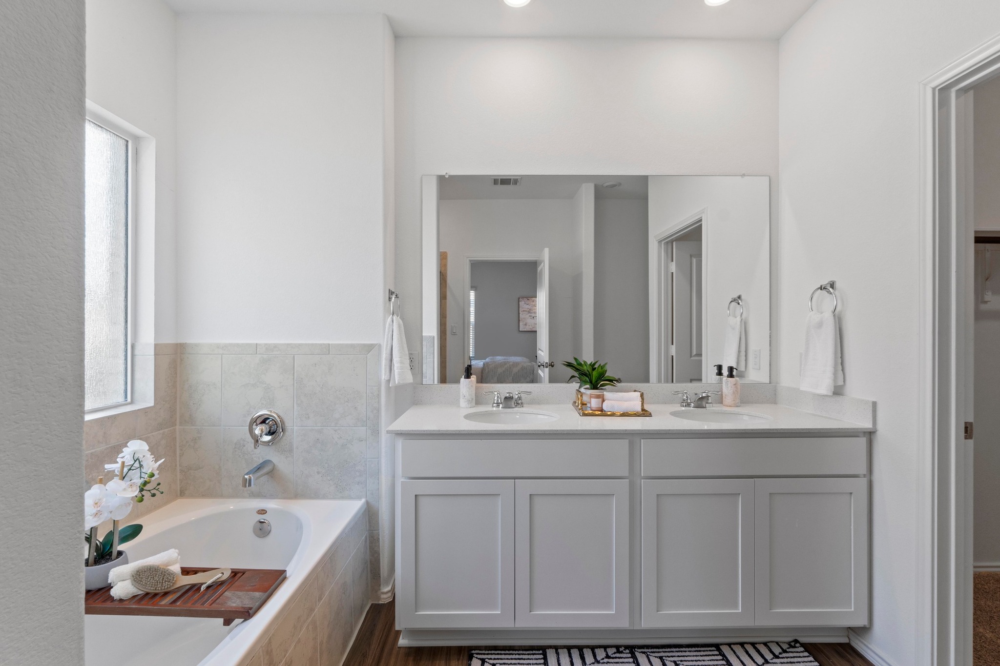 1705 Woolsey Way Leander, TX 78641 - Photo 21 of 35 a bathroom with a tub sink and mirror