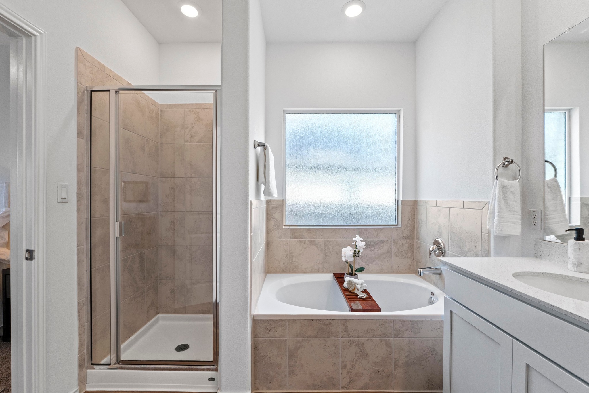 1705 Woolsey Way Leander, TX 78641 - Photo 23 of 35 a bathroom with a tub a sink a mirror a shower and vanity