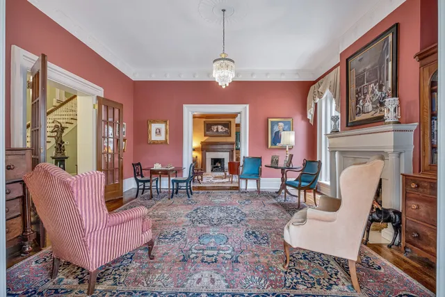a living room with furniture and a chandelier