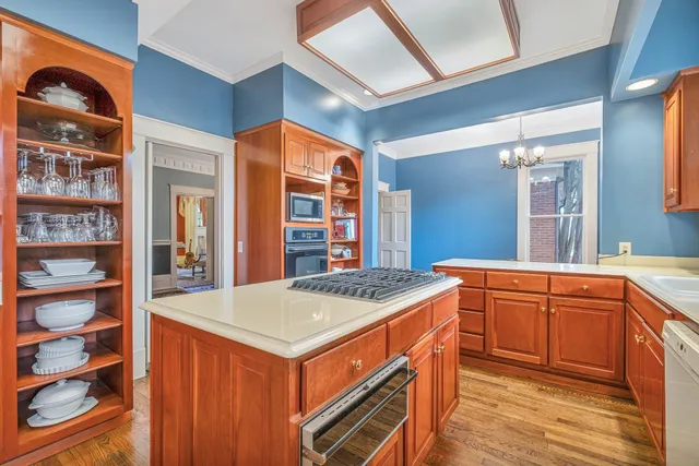 a spacious bedroom with a bed a window and dresser