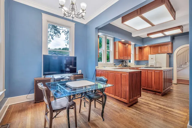 a bedroom with a bed and a chandelier