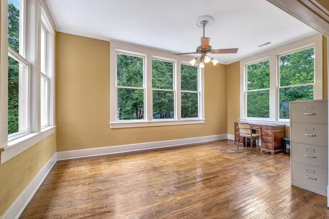 wooden floor in an empty room with a window