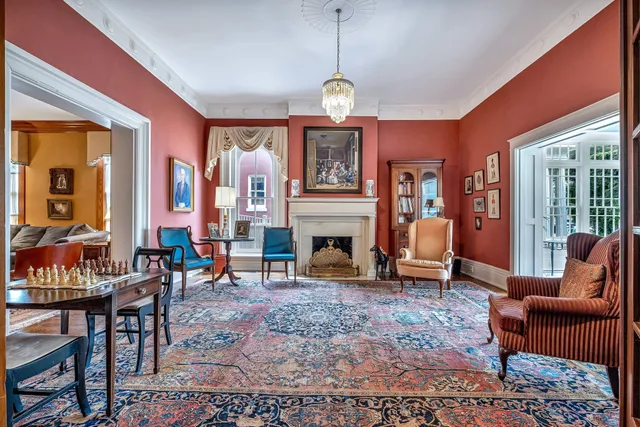 a living room with fireplace furniture and a large window
