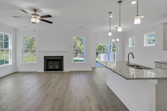 a kitchen with a sink chandelier and a fireplace