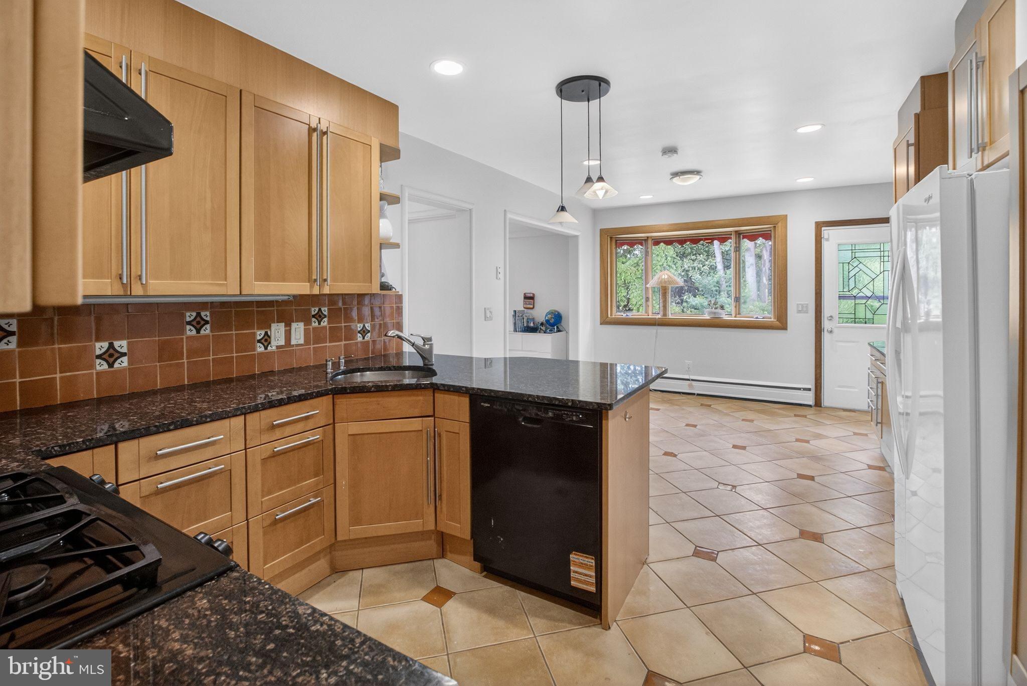 5804 Plainview Road Bethesda, MD 20817 - Photo 11 of 34 a kitchen with stainless steel appliances granite countertop a refrigerator and a sink