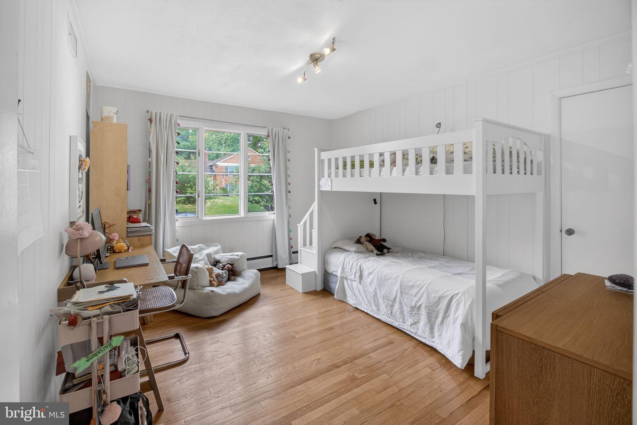 5804 Plainview Road Bethesda, MD 20817 - Photo 17 of 34 a bedroom with a bed and wooden floor