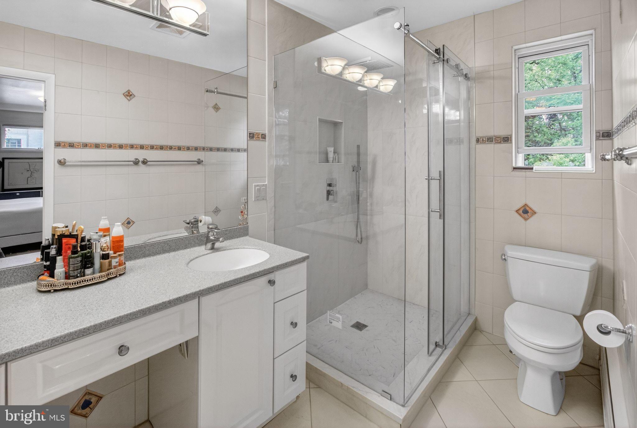 5804 Plainview Road Bethesda, MD 20817 - Photo 18 of 34 a bathroom with a sink a toilet and shower