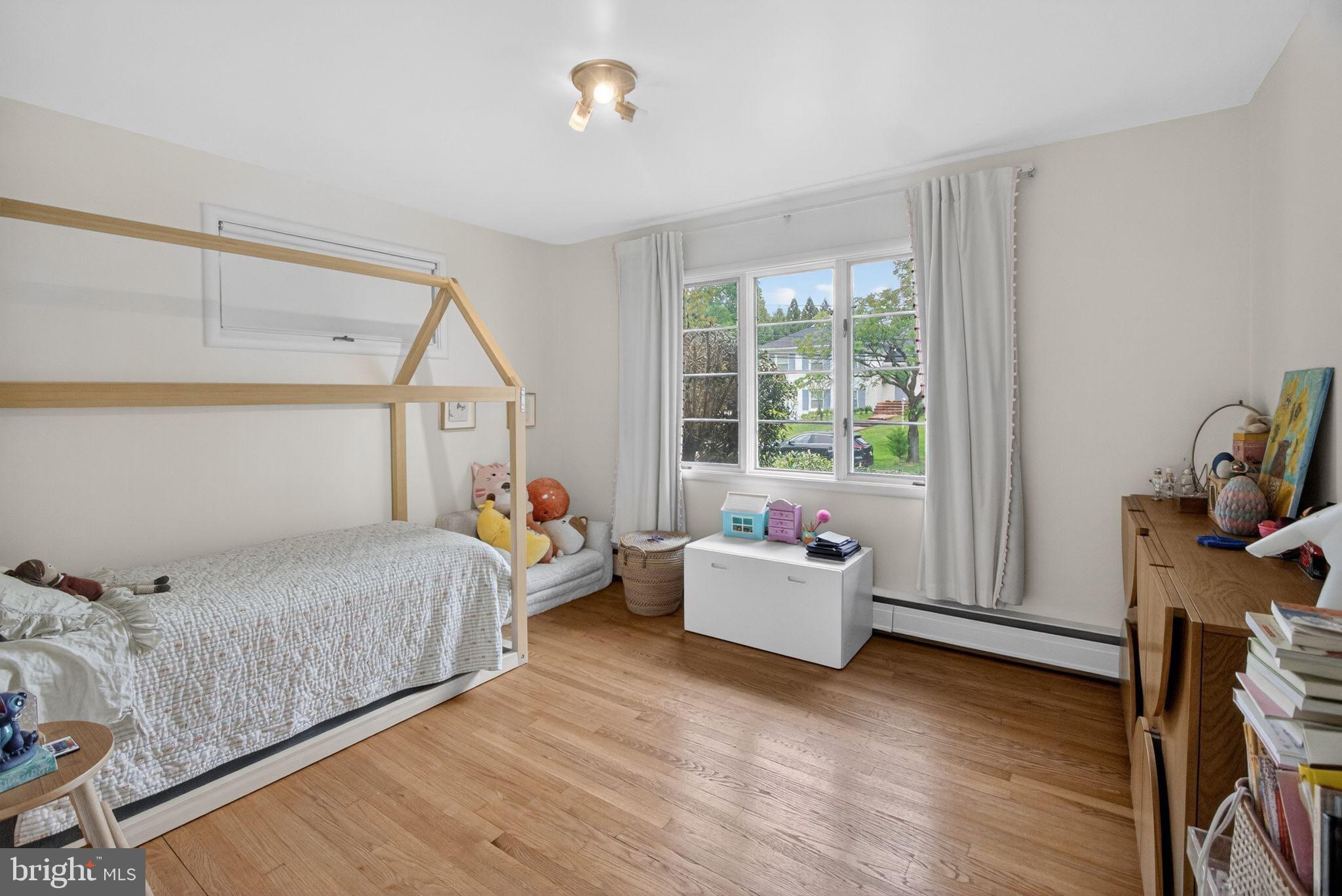 5804 Plainview Road Bethesda, MD 20817 - Photo 19 of 34 a bedroom with a bed and wooden floor