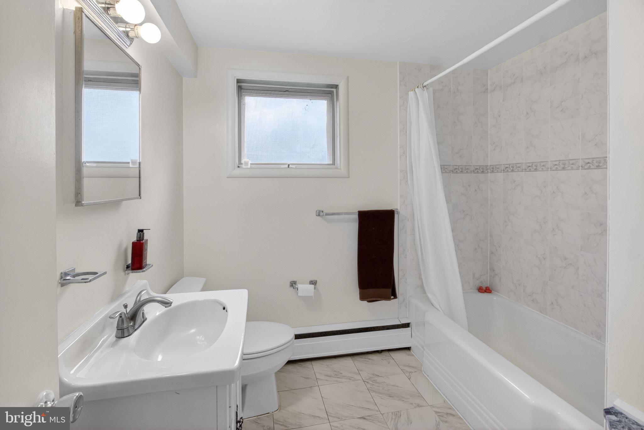 5804 Plainview Road Bethesda, MD 20817 - Photo 29 of 34 a bathroom with a sink a toilet and shower