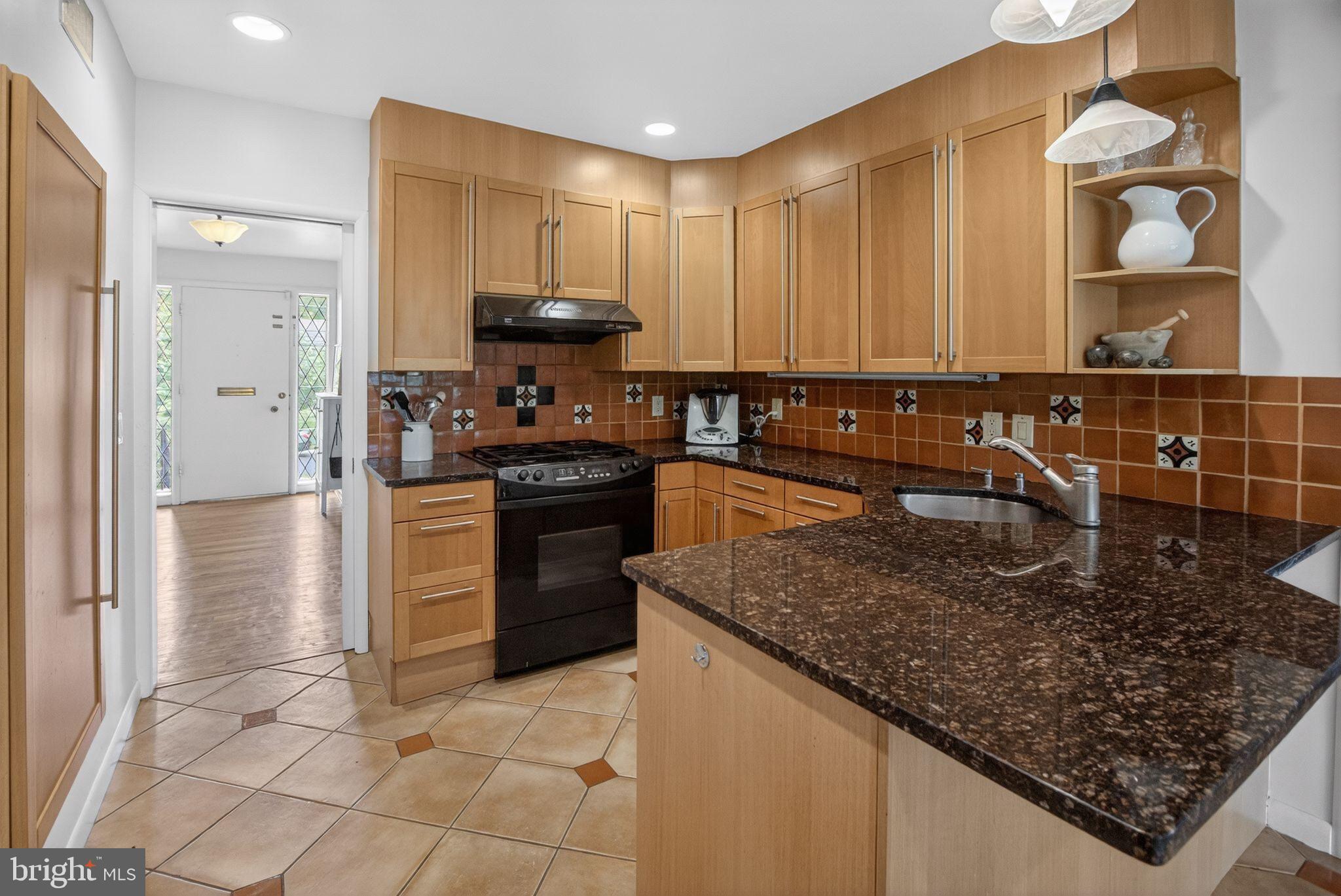 5804 Plainview Road Bethesda, MD 20817 - Photo 9 of 34 a kitchen with stainless steel appliances granite countertop a sink stove and refrigerator