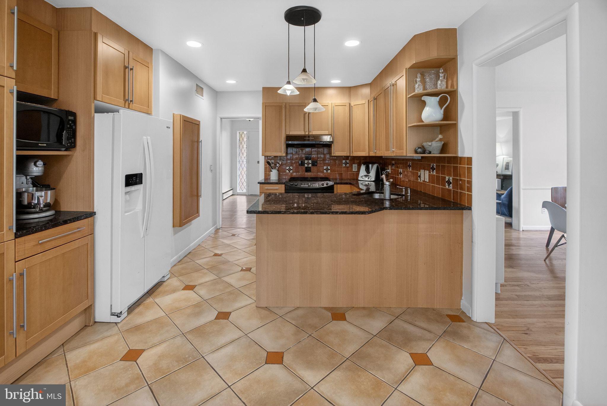 5804 Plainview Road Bethesda, MD 20817 - Photo 10 of 34 a kitchen with stainless steel appliances granite countertop a refrigerator a oven and a sink