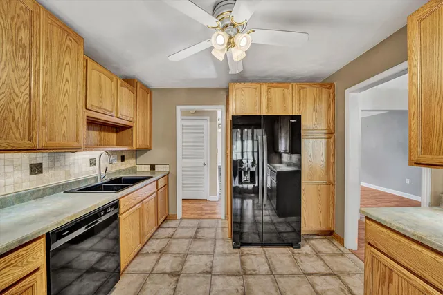 a kitchen with stainless steel appliances granite countertop a refrigerator a sink a stove and island