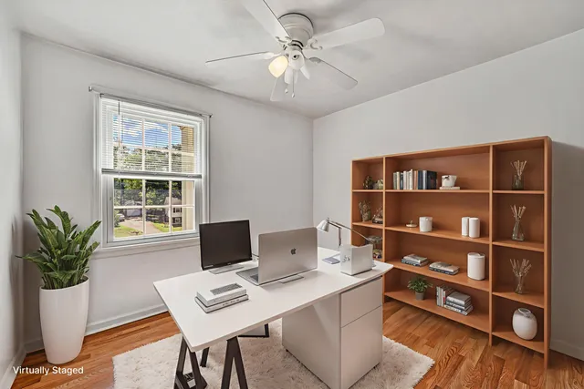 a view of a workspace with furniture and a potted plant