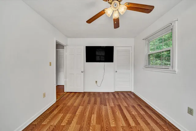 wooden floor in an empty room with a window