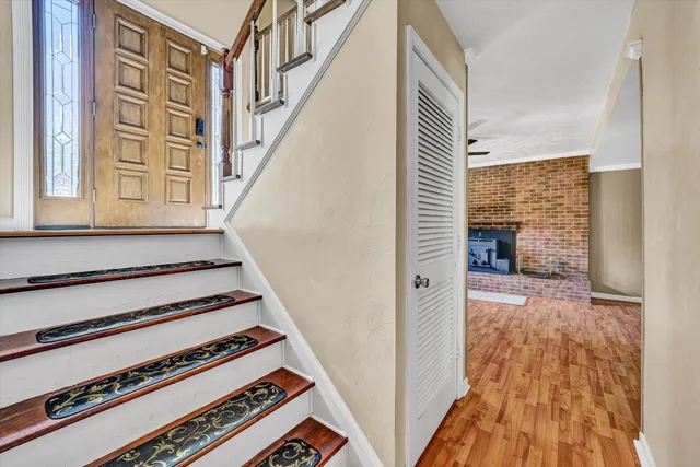 a view of a stairs and wooden floor