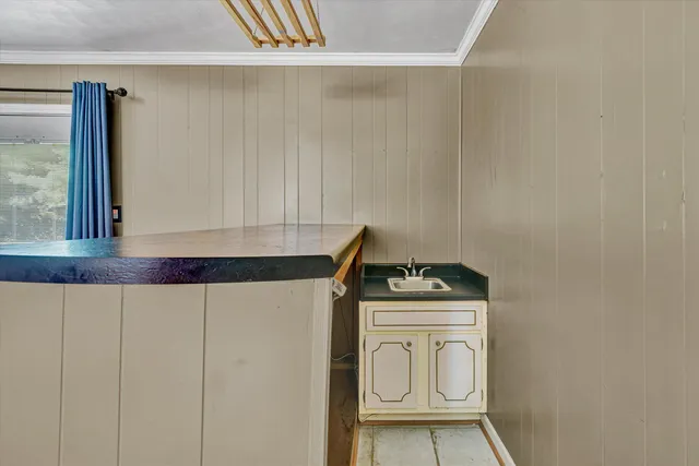 a bathroom with a granite countertop sink and a stove