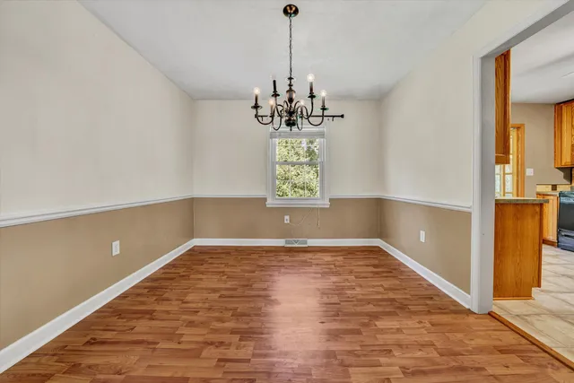 a view of a room with window and wooden floor