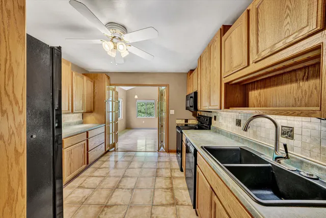 a kitchen with a sink a stove cabinets and stainless steel appliances