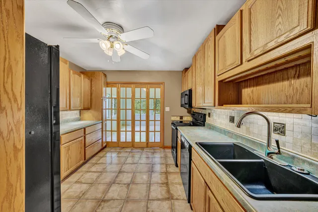 a kitchen with a sink cabinets and appliances