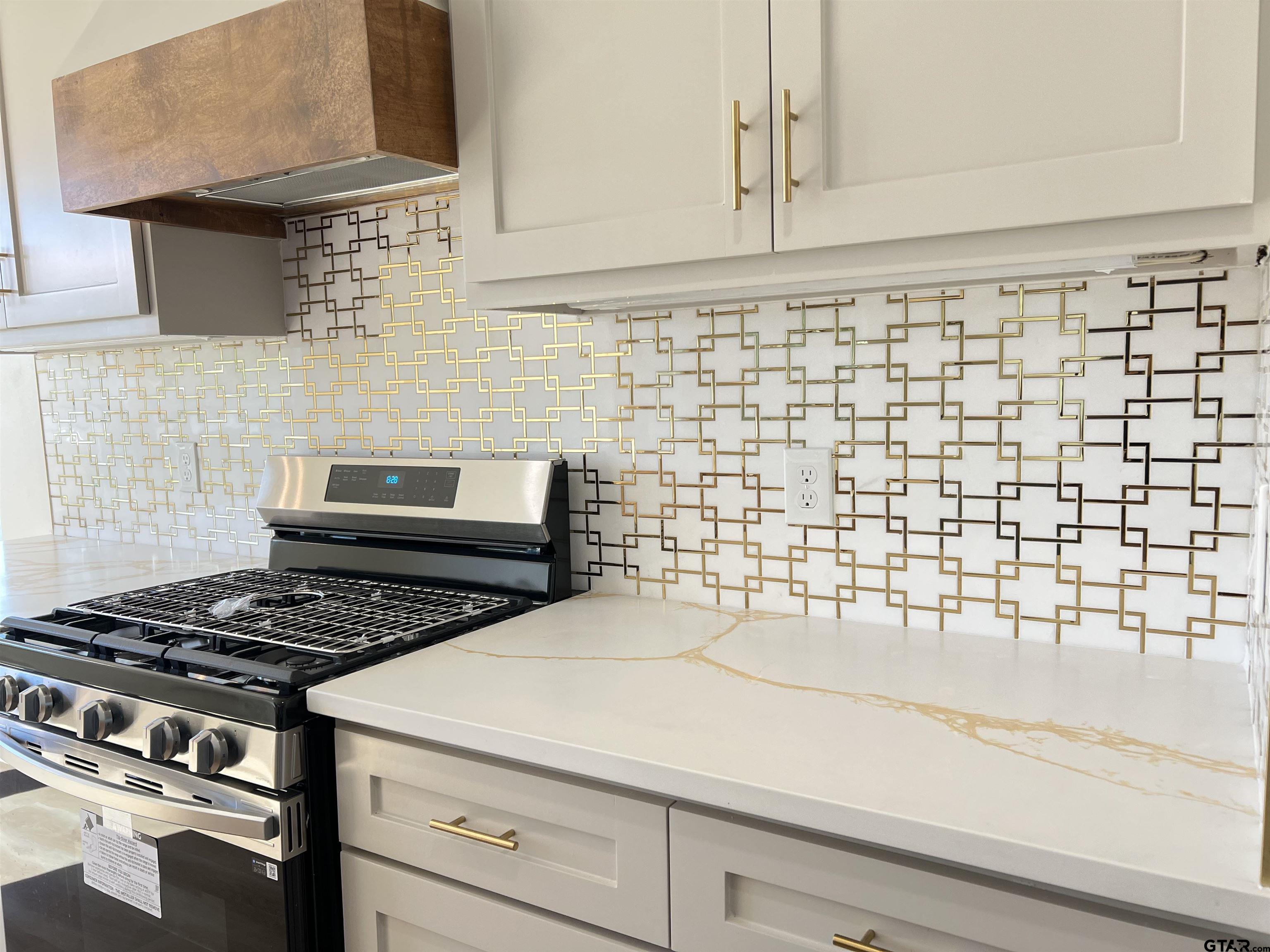 242 Sides Bullard, TX 75757 - Photo 11 of 41 a kitchen with a stove and a white cabinet