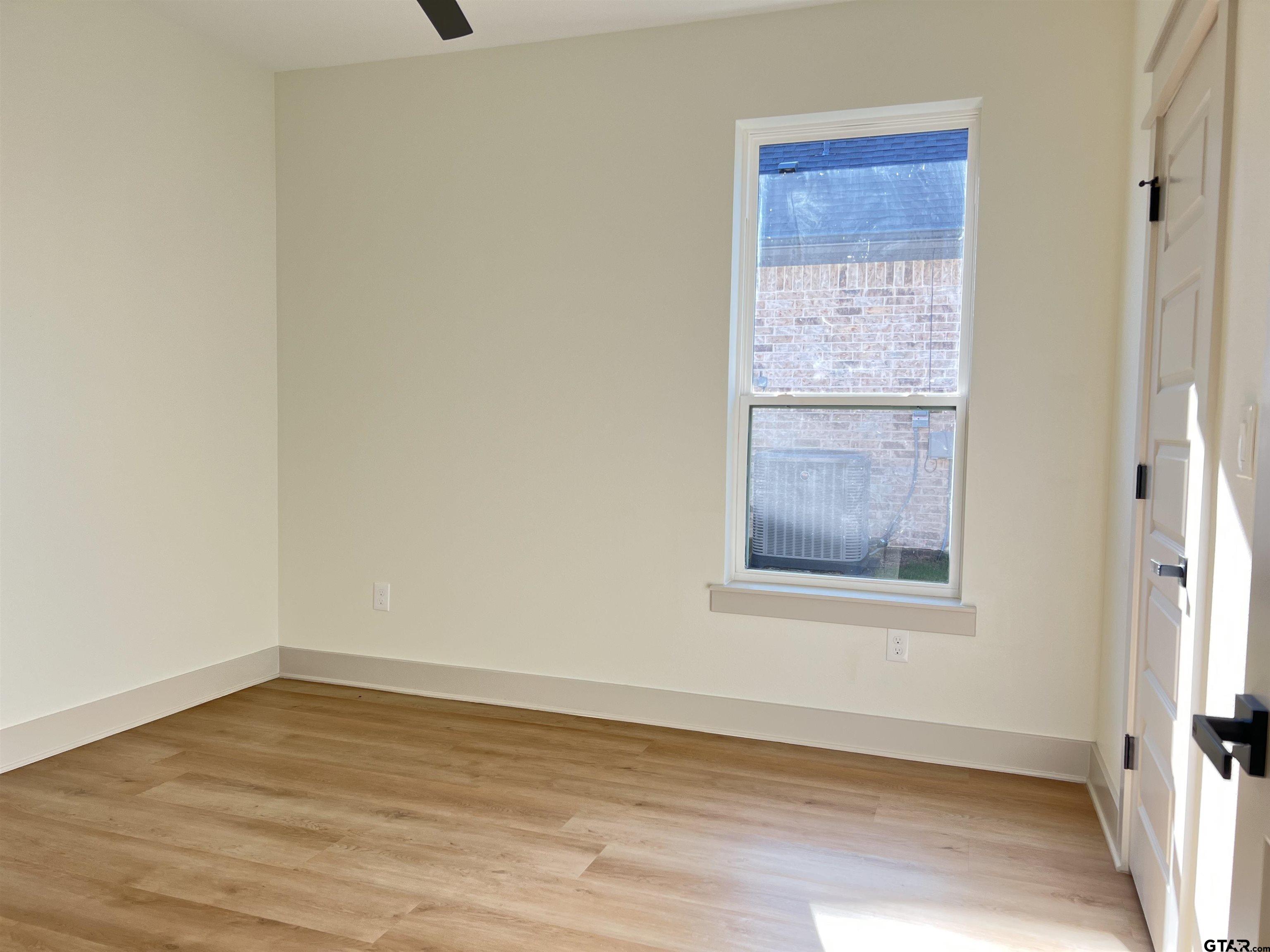 242 Sides Bullard, TX 75757 - Photo 28 of 41 a view of an empty room with wooden floor and a window