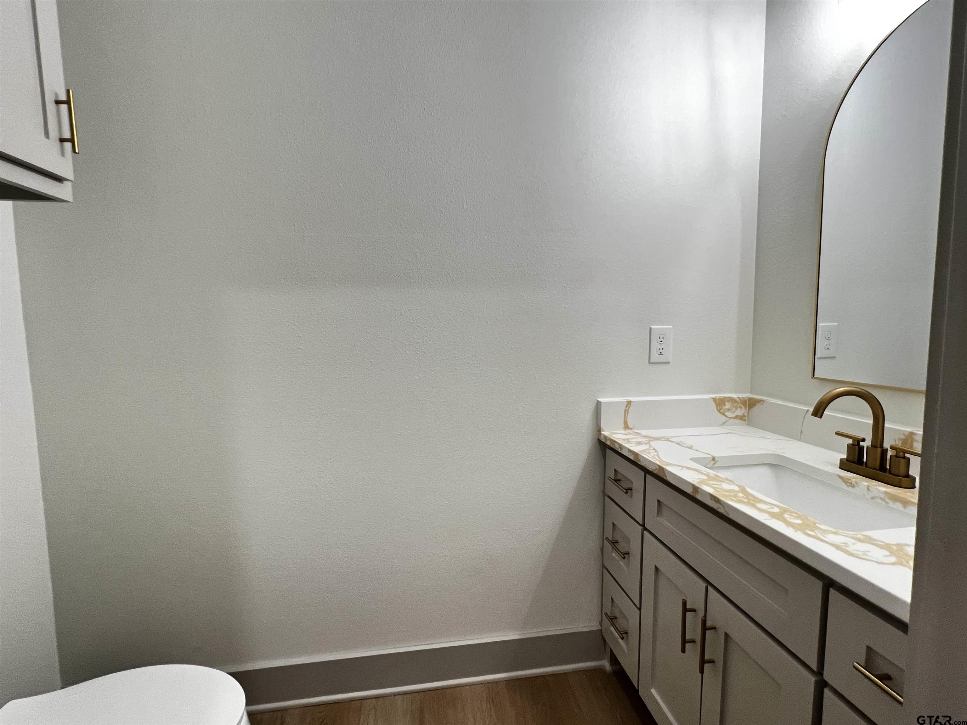 242 Sides Bullard, TX 75757 - Photo 29 of 41 a bathroom with a granite countertop sink a toilet and a mirror