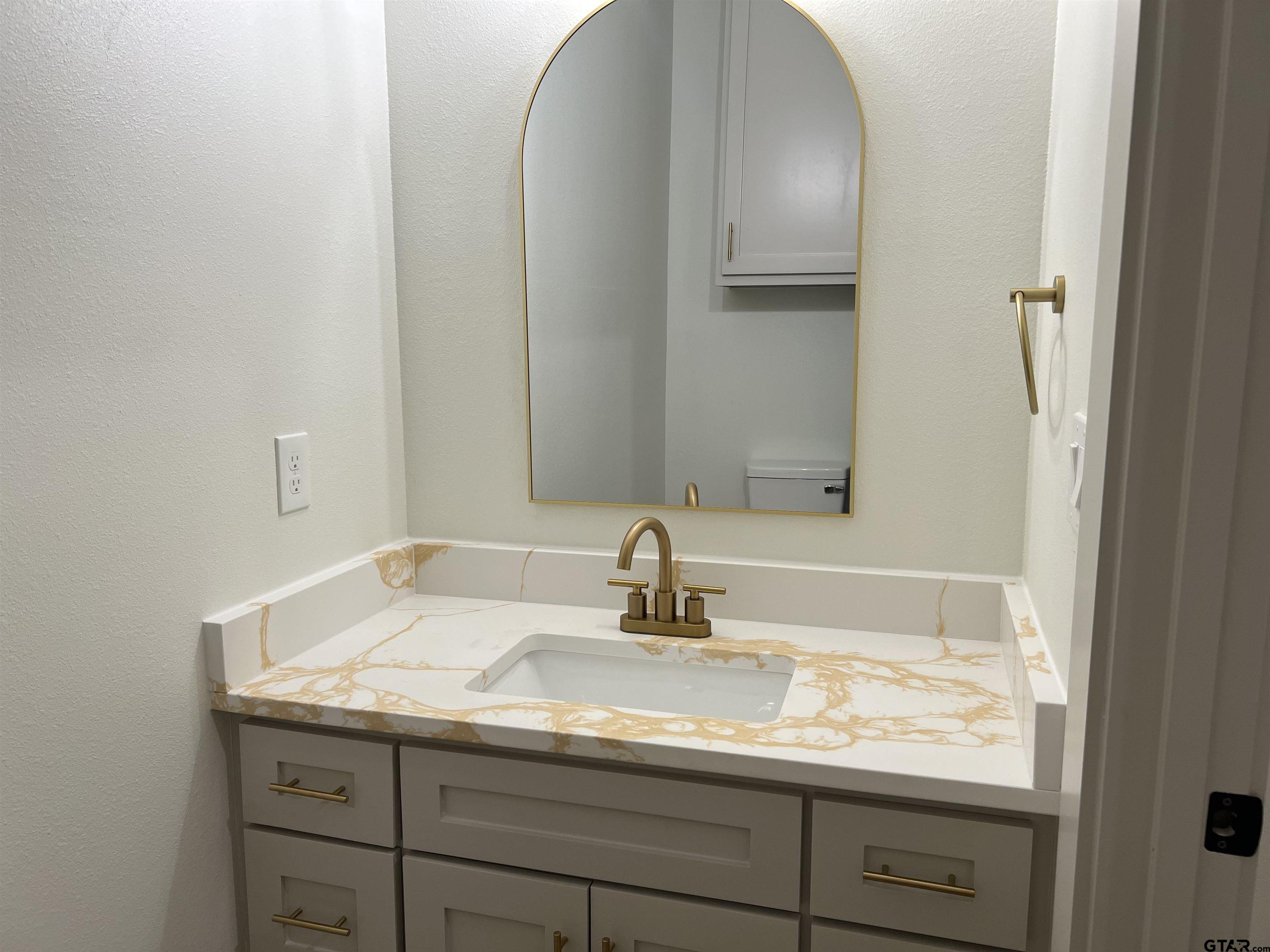 242 Sides Bullard, TX 75757 - Photo 30 of 41 a bathroom with a sink and a mirror