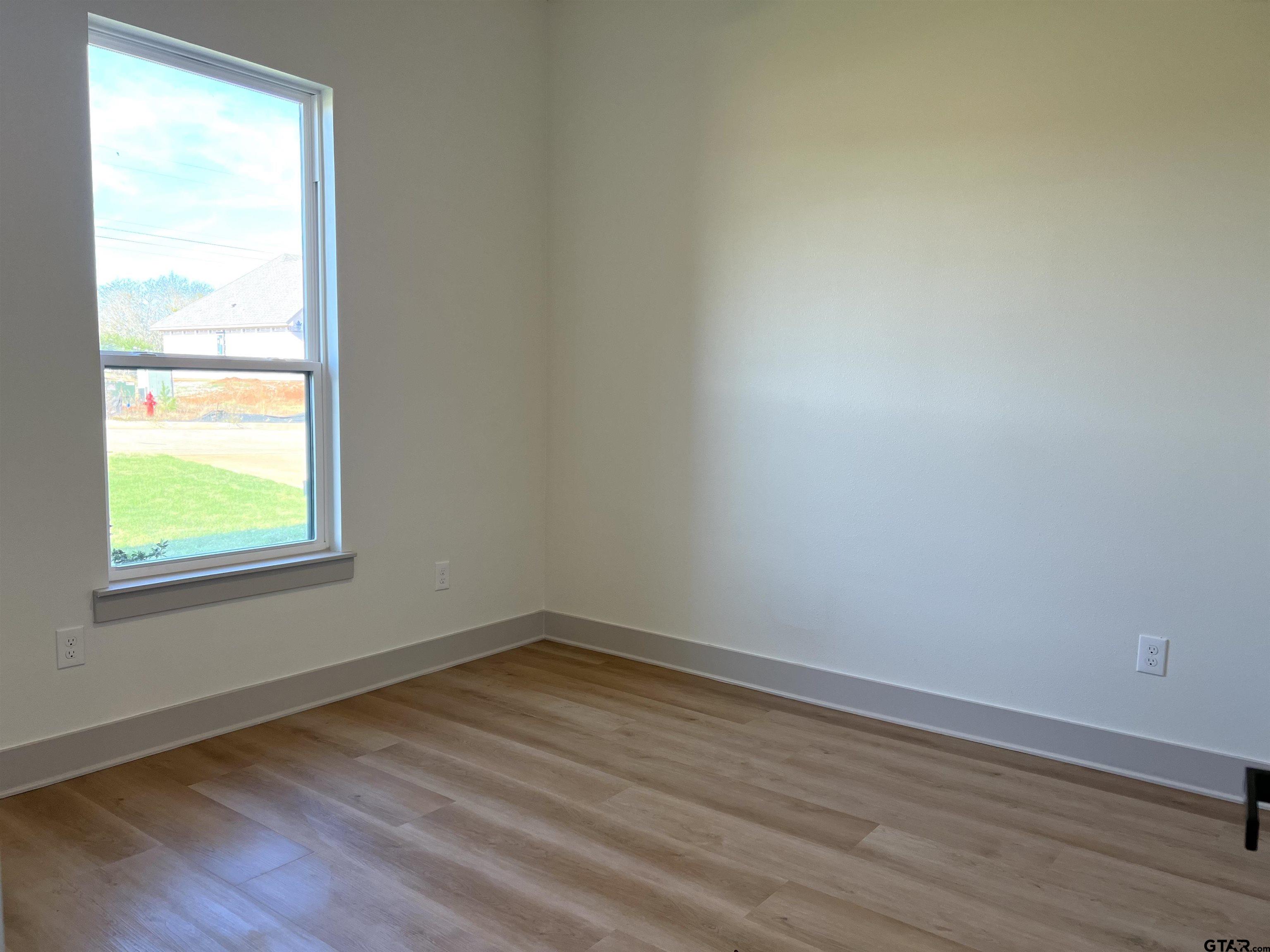242 Sides Bullard, TX 75757 - Photo 3 of 41 an empty room with wooden floor and windows