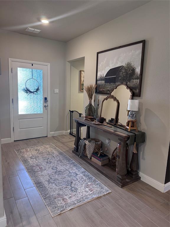 1908 Cookes Lane Cleburne, TX 76033 - Photo 4 of 17 Entryway with door featuring textured glass, recessed lighting, and wood-finish flooring