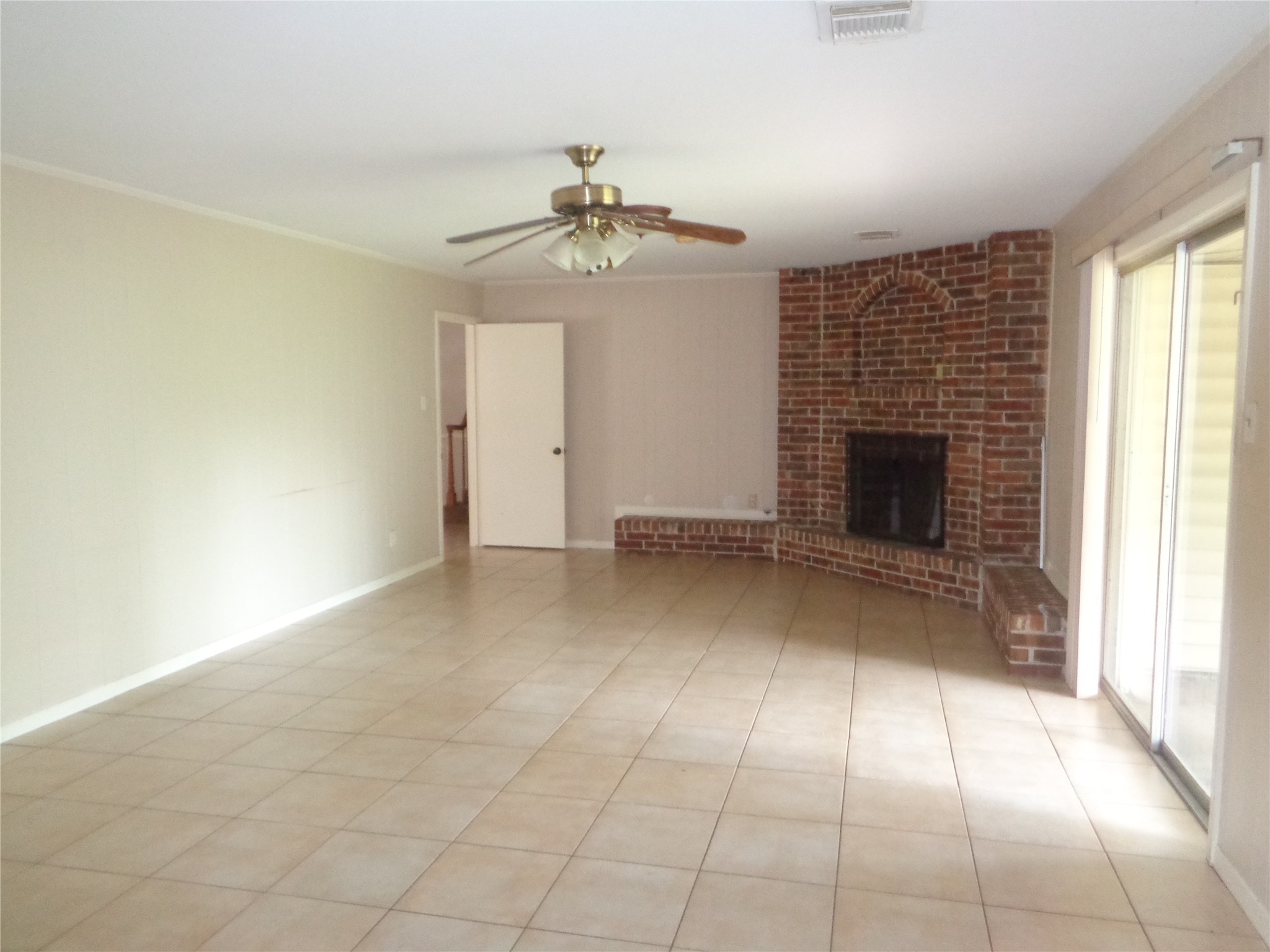 11215 Mayfield Road Houston, TX 77043 - Photo 4 of 16 an empty room with windows and fireplace