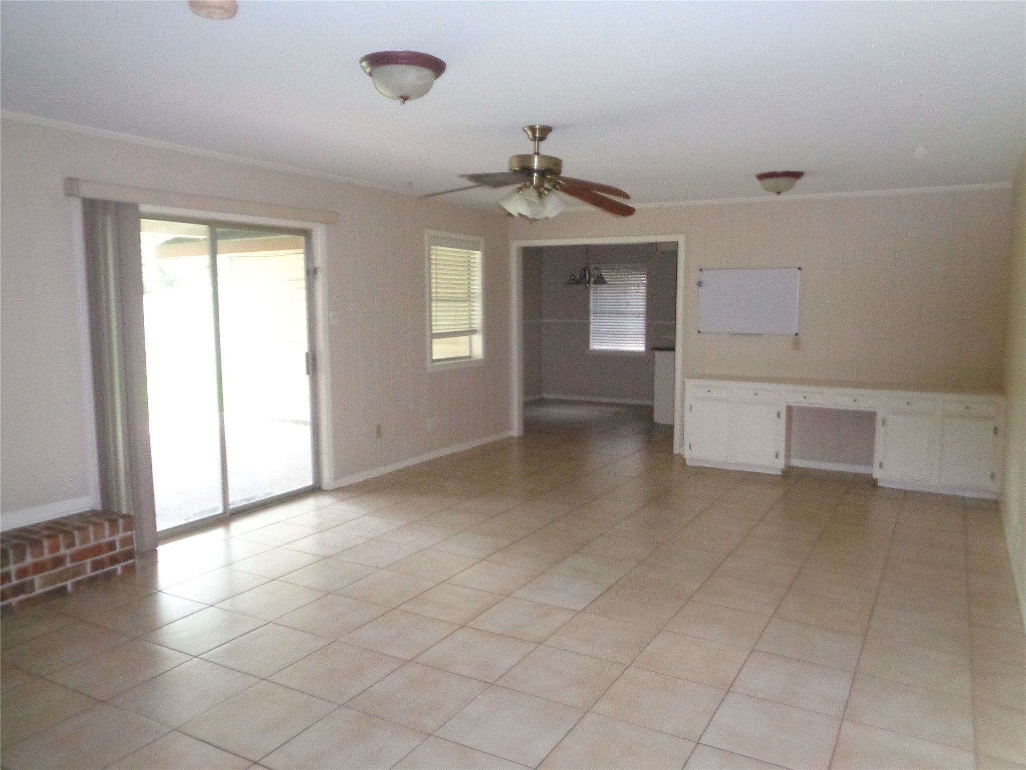 11215 Mayfield Road Houston, TX 77043 - Photo 5 of 16 an empty room that has a window and kitchen view