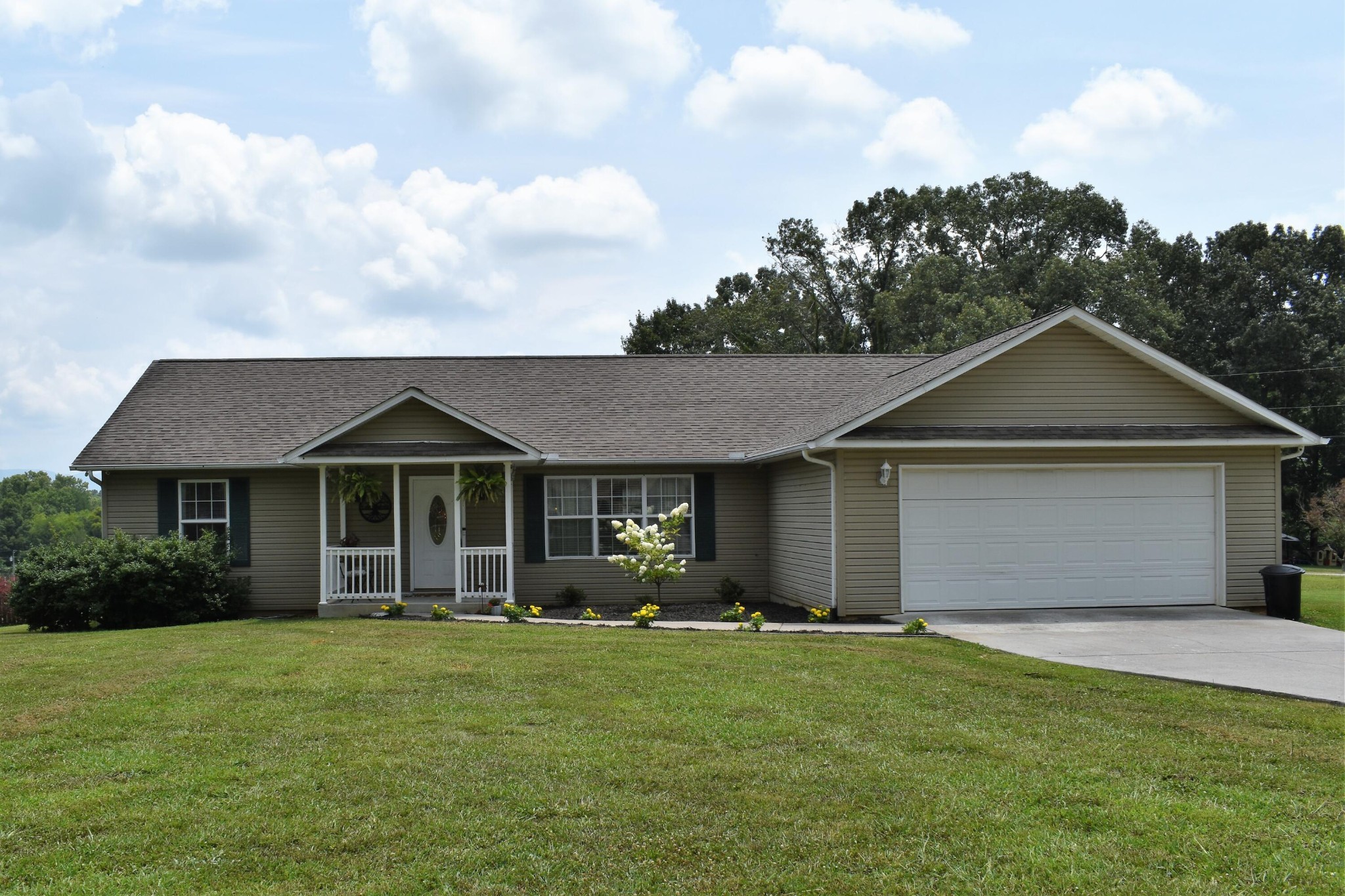 a front view of house with yard and green space