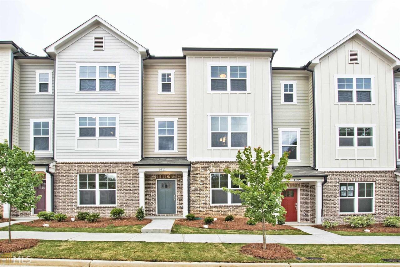 1611 Falcon Crest Way, Unit 51 Decatur, GA 30032 - Photo 1 of 1 a front view of a house with a yard and garage