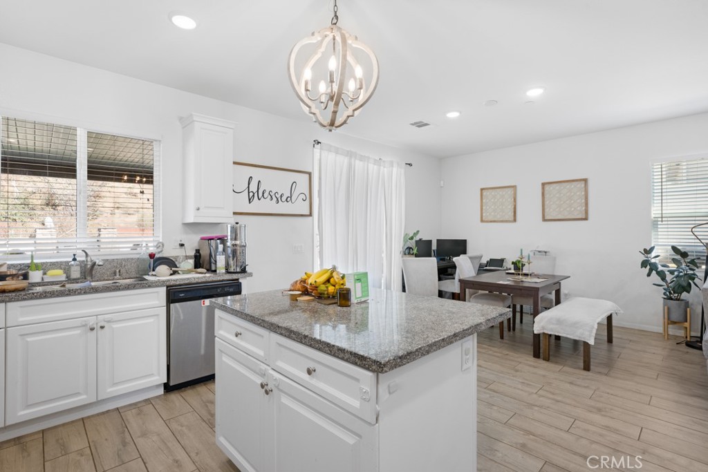 20920 Spring Street Riverside, CA 92507 - Photo 13 of 30 a kitchen with sink cabinets and dining table