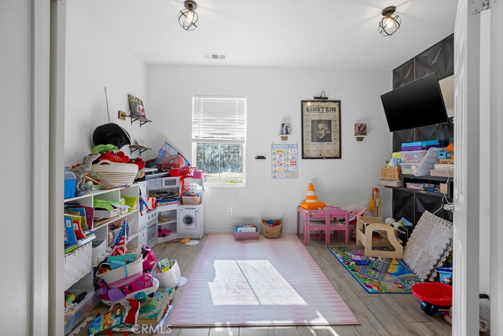 20920 Spring Street Riverside, CA 92507 - Photo 15 of 30 a children room with toys and a flat screen tv