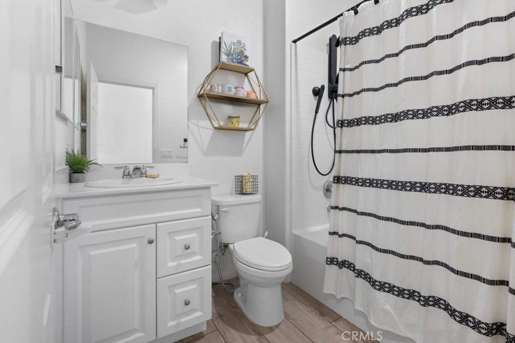 20920 Spring Street Riverside, CA 92507 - Photo 17 of 30 a bathroom with a granite countertop sink mirror vanity and toilet