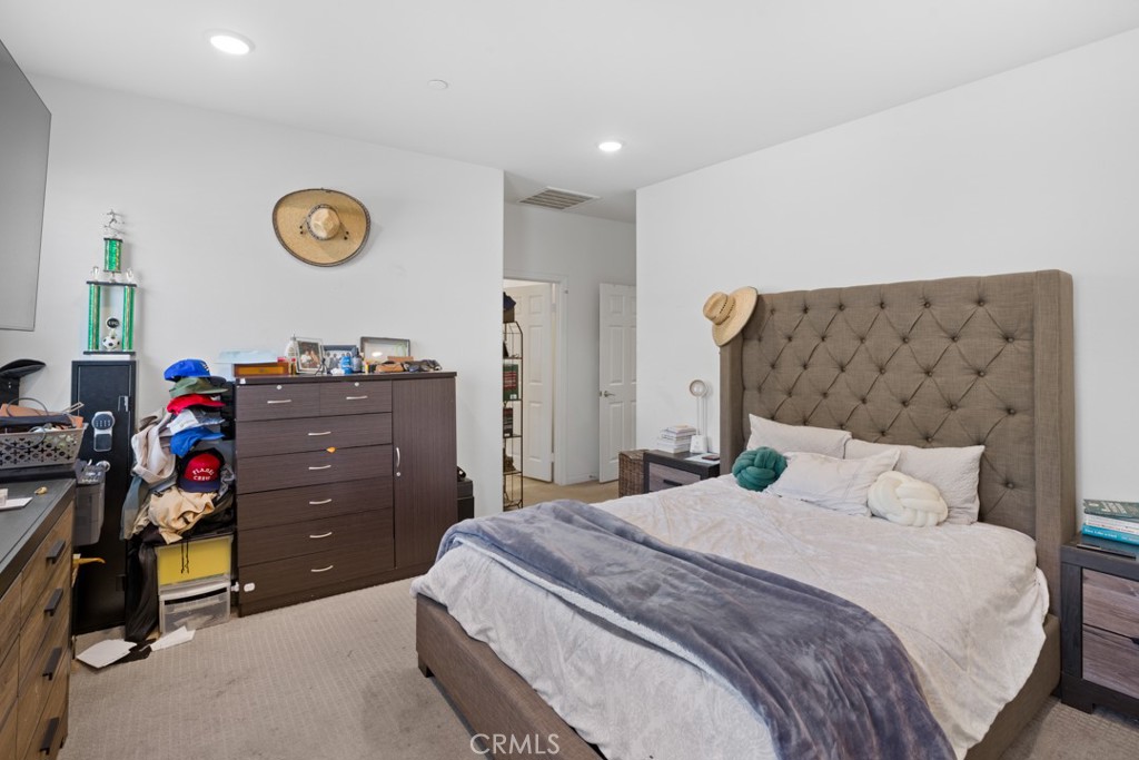 20920 Spring Street Riverside, CA 92507 - Photo 19 of 30 a bedroom with a bed and a chandelier