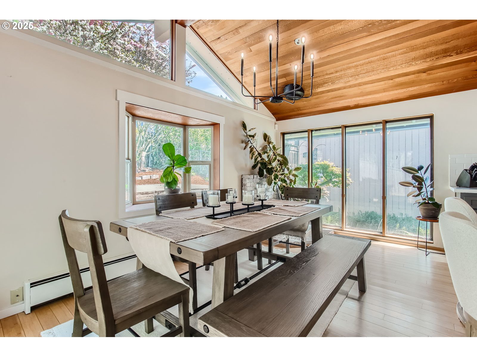 6121 Southwest Wilbard Street Portland, OR 97219 - Photo 12 of 28 a view of a dining room with furniture window and wooden floor