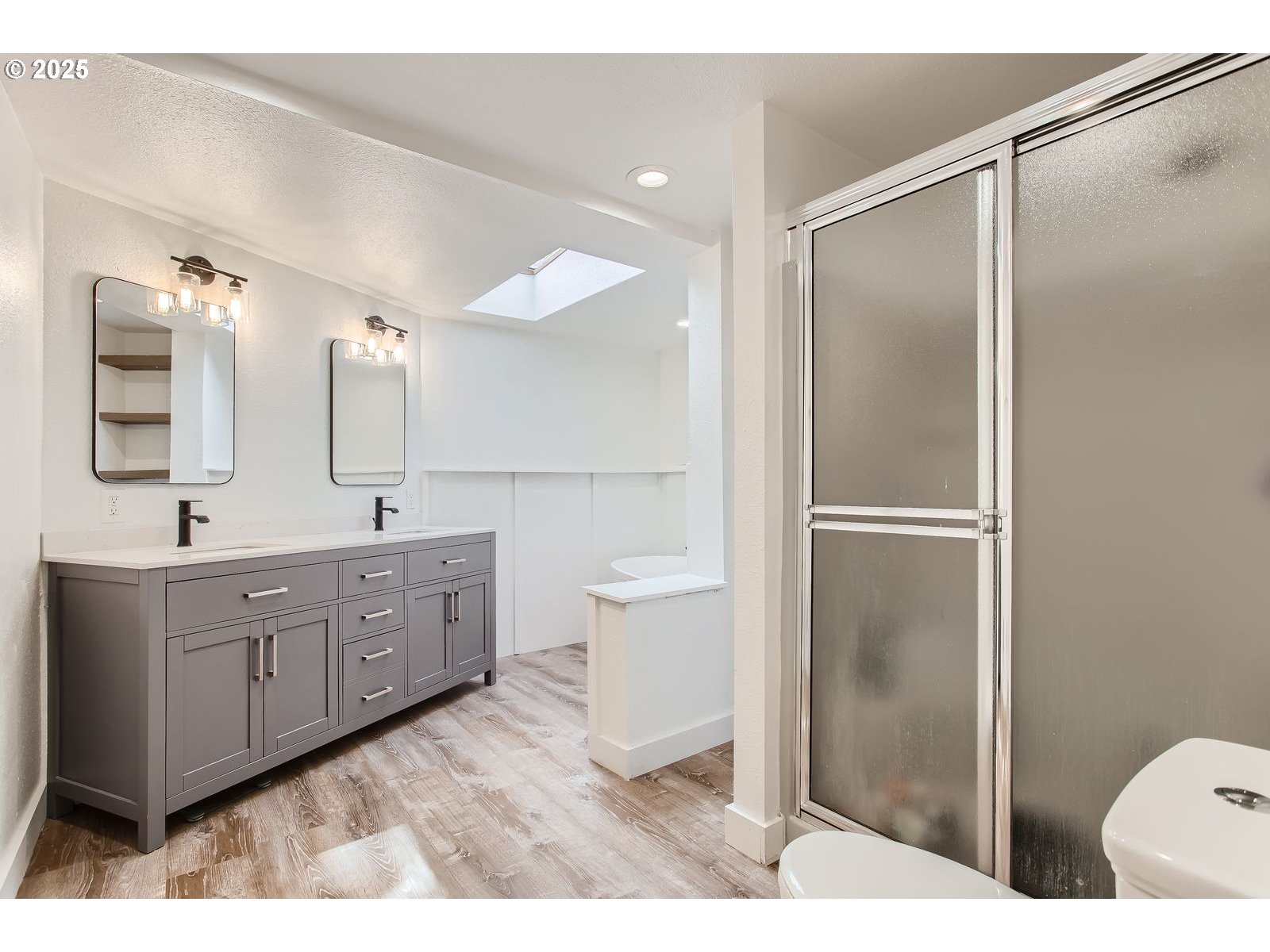 6121 Southwest Wilbard Street Portland, OR 97219 - Photo 16 of 28 a bathroom with a double vanity sink mirror and toilet