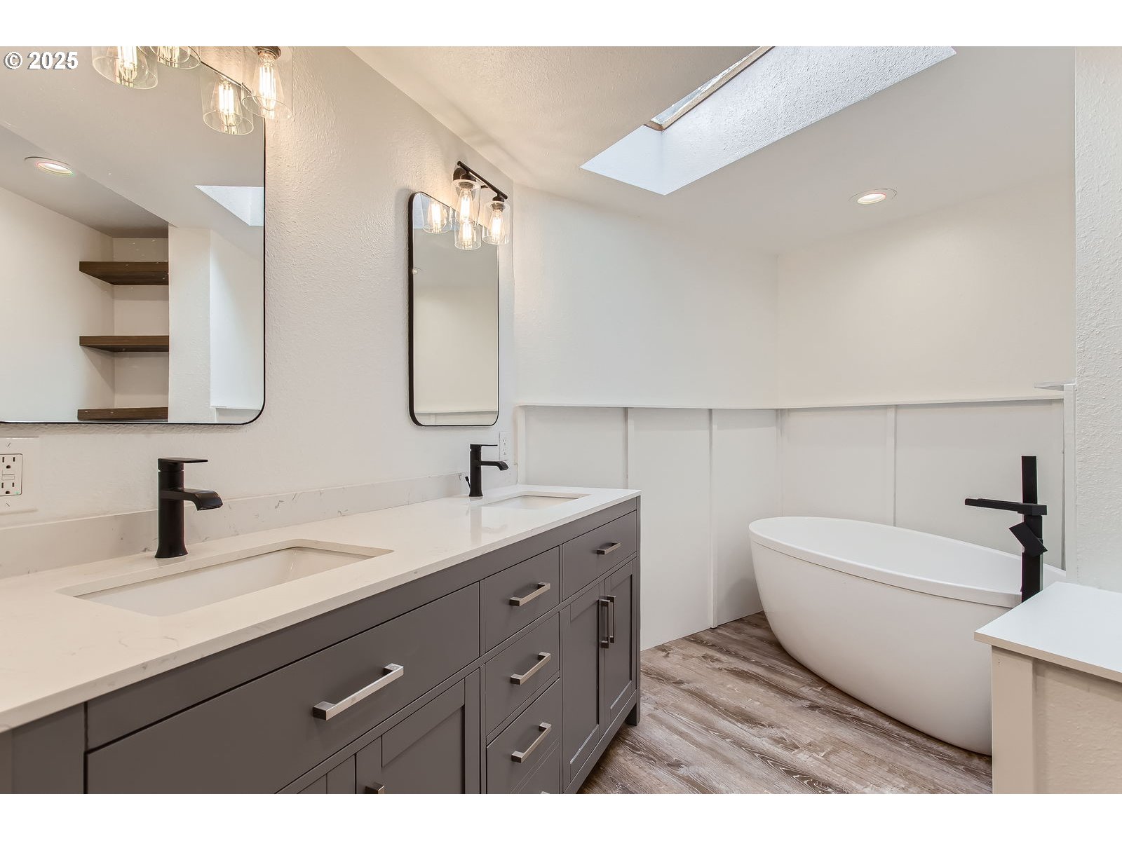 6121 Southwest Wilbard Street Portland, OR 97219 - Photo 17 of 28 a bathroom with a double vanity sink and mirror