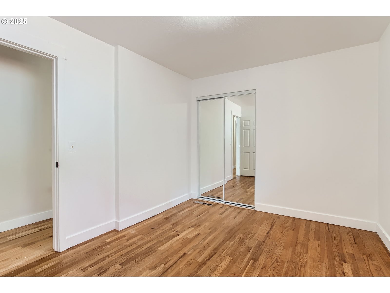 6121 Southwest Wilbard Street Portland, OR 97219 - Photo 19 of 28 an empty room with wooden floor