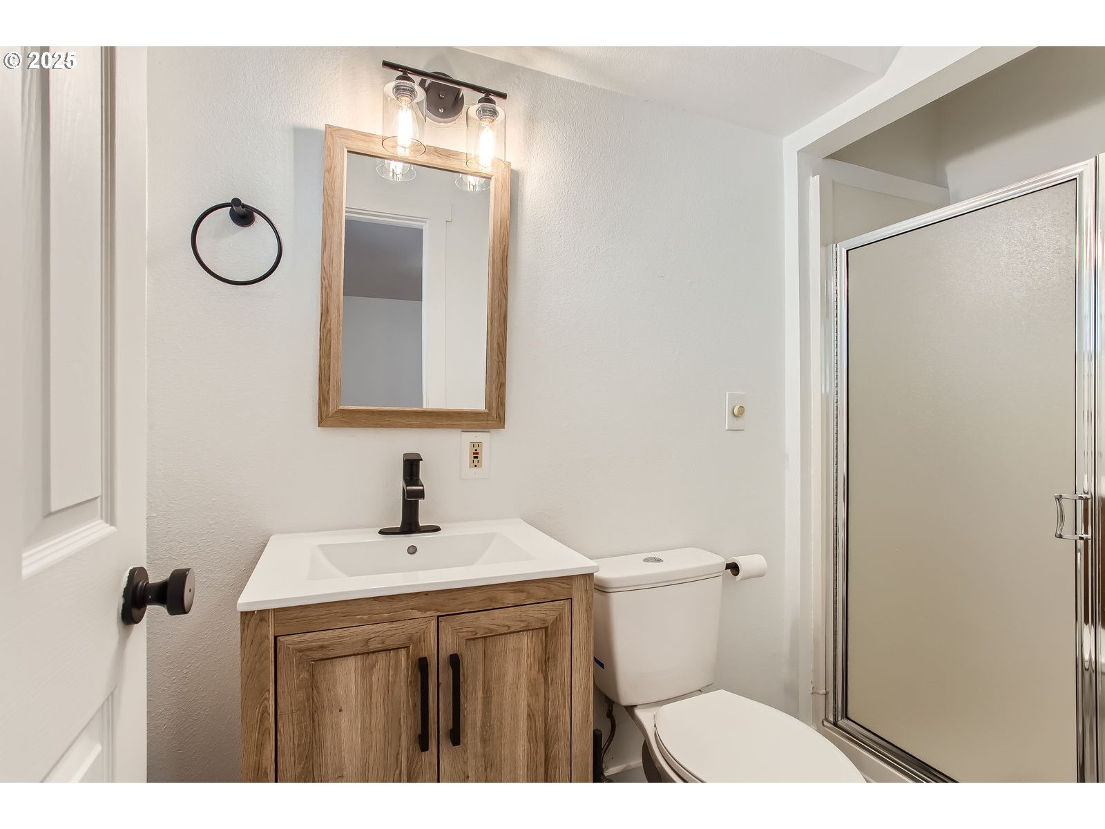 6121 Southwest Wilbard Street Portland, OR 97219 - Photo 20 of 28 a bathroom with a sink a toilet and mirror