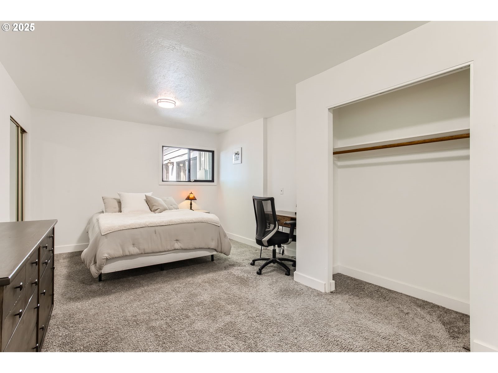 6121 Southwest Wilbard Street Portland, OR 97219 - Photo 22 of 28 a bed room with a bed and a chair