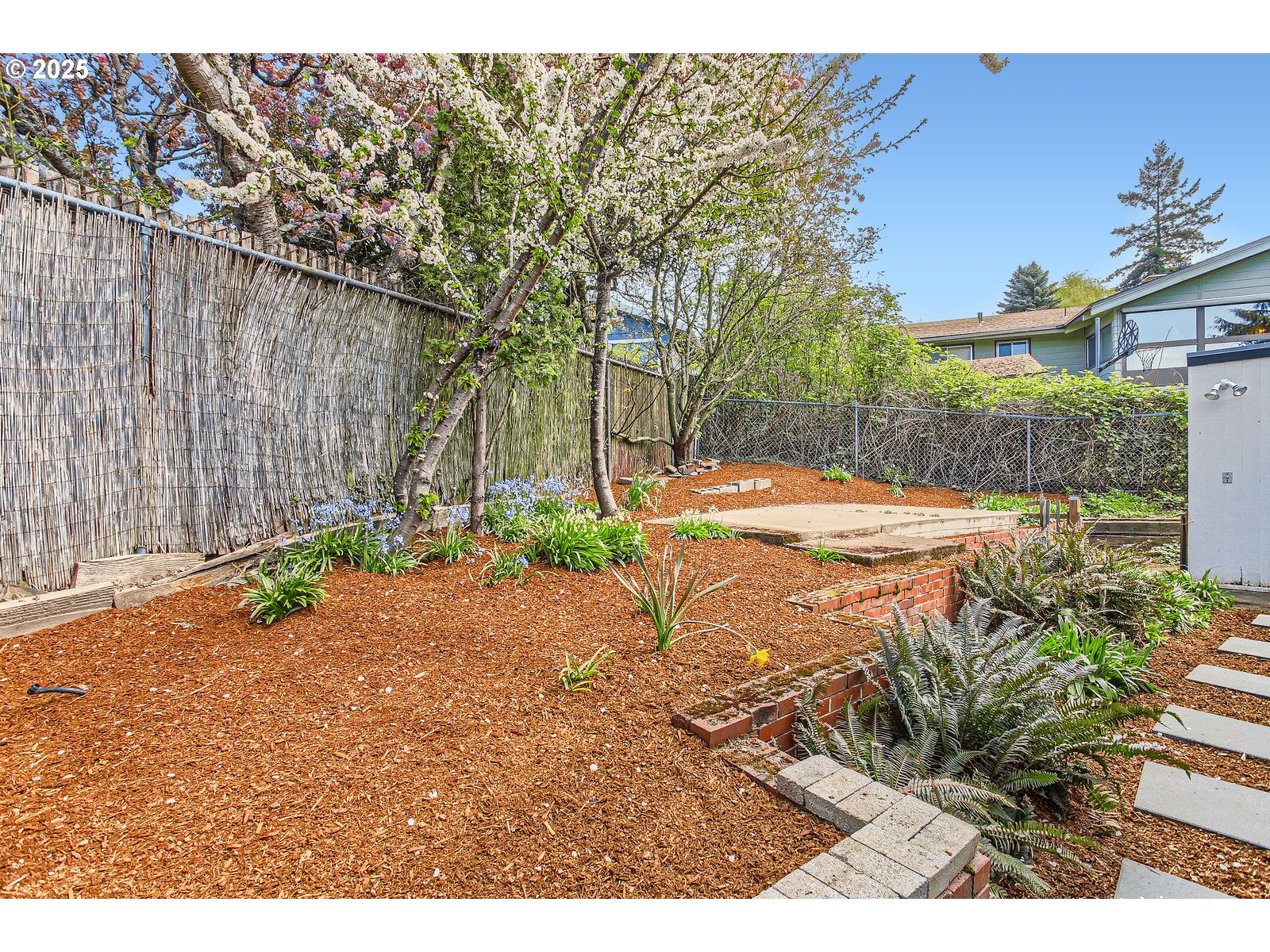 6121 Southwest Wilbard Street Portland, OR 97219 - Photo 27 of 28 a backyard of a house with a yard and outdoor seating