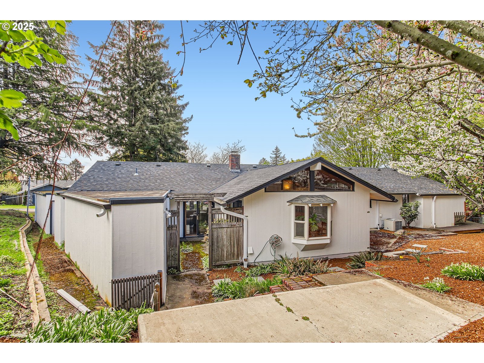 6121 Southwest Wilbard Street Portland, OR 97219 - Photo 28 of 28 a white house with a tree in the background
